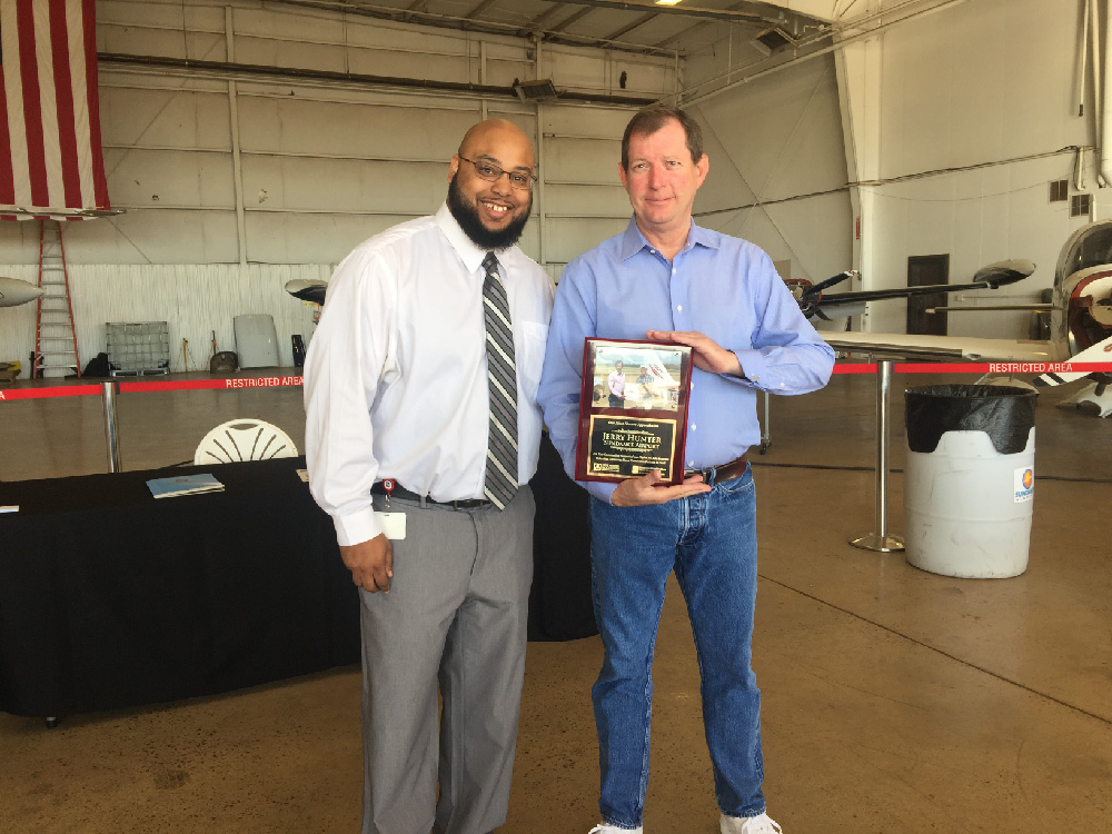 Carvin Brown gives Jerry Hunter an Award of Appreciation for everything he has done to help Flights For Life and OBI.